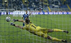 Northern Ireland goalkeeper Bailey Peacock-Farrell stops a shot from Bosnia's Haris Hajradinovic during a penalty shootout at the end of the Euro 2020 playoff semifinals soccer match between Bosnia-Herzegovina and Northern Ireland at the Grbavica stadium, in Sarajevo, Bosnia, Thursday, Oct. 8, 2020. (AP Photo/Kemal Softic)