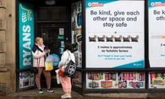 October 2020: college students Olivia Bartlett and Sianne Clabin shelter from the rain outside a newsagents in Huddersfield