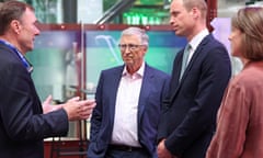 Bill Gates and Prince William listen to a delegate at a conference venue