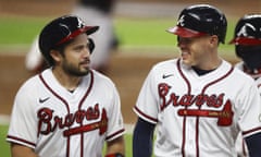 The Braves’ Travis D’Arnaud, left, laughs with Freddie Freeman during their rout against the Marlins