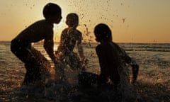 Children play in the Mediterranean Sea, off the coast of Libya.