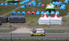An ambulance passes a scout camping site during the World Scout Jamboree in Buan, South Korea, on Wednesday. Hundreds have been affected by heat-related illness this week.