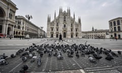 Pigeons take posses of an almost desert Duomo square, in downtown Milan, Italy, Friday, Nov. 6, 2020. Lombardy is among the four Italian regions classified as red zones, where a strict lockdown was imposed starting Friday - to be reassessed in two weeks - in an effort to curb the COVID-19 infections growing curve. Starting today, only shops selling food and other essentials are allowed to open. (Claudio Furlan/LaPresse via AP)