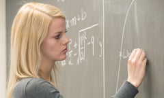 Woman writing mathematical formulas on a blackboard