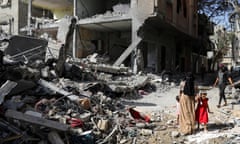 Aftermath of Israeli strikes at the area where Israeli hostages were rescued on Saturday, in Nuseirat refugee camp<br>A woman and child walk among debris, aftermath of Israeli strikes at the area, where Israeli hostages were rescued on Saturday, as Palestinian death toll rises to 274, amid the Israel-Hamas conflict, in Nuseirat refugee camp in the central Gaza Strip, June 9, 2024. REUTERS/Abed Khaled