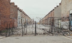 Belfast Dividing Line<br>View of a hastily constructed barbed wire fence that runs across a terraced street to mark a peace line or dividing line between republican and neighbouring loyalist areas of Belfast, Northern Ireland during The Troubles in April 1972. (Photo by Rolls Press/Popperfoto via Getty Images/Getty Images)