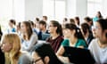 University Students Listening And Concentrating During Lecture<br>A group of students listening and concentrating on their tutor during a lecture at university.