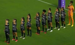 Corinthians’ players cover their ears and mouths in protest before their game against Santos