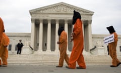 Demonstrators with Witness Against Torture in orange jumpsuits and black hoods prepare to march from the US Supreme Court to the DC Superior Court in Washington, DC,on May 27, 2008 protesting that the rights and humanity of Guantanamo Bay detainees be respected. AFP PHOTO/Jim WATSON (Photo credit should read JIM WATSON/AFP via Getty Images)