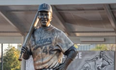 a bronze statue of a man holding a baseball bat