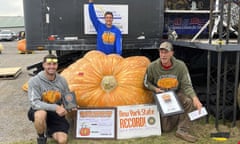 Scott Andrusz, right, poses with the record-setting pumpkin in Clarence, New York, on Saturday, 1 October 2022.