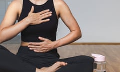 Woman doing breathing exercise sitting in lotus position