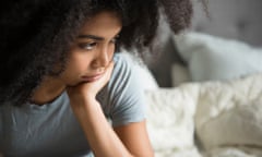 Unhappy woman sitting in bed