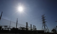 An electrical substation in front of an electricity pylon