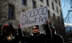 A demonstrator holds a sign at the “Rally to End the Shutdown” in Washington, DC.