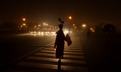 A woman crosses the road in New Delhi.