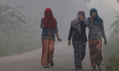 Villagers shrouded by haze on the Indonesian island of Sumatra