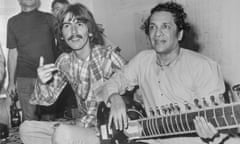 George Harrison with Indian Musician<br>(Original Caption) Hollywood: Beatle George Harrison, (L), listens as Ravi Shanker of India plays the sitar, 8/3, a 25-stringed guitar-like instrument. Harrison said he is studying the sitar under Shanker, because Indian music makes God come through in a spiritual way." Harrison is vacationing in Southern California.