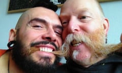 Close up of How We Met couple Bjorn and Jos - both bearded and mustachioed, with Jos's moustache between Bjorn's teeth