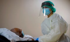 US-HEALTH-VIRUS-HOSPITAL-PANDEMIC-COMMUNITIES<br>A healthcare worker tends to a patient in the Covid-19 Unit at United Memorial Medical Center in Houston, Texas, July 2, 2020. - Despite its renowned medical center with the largest agglomeration of hospitals and research laboratories in the world, Houston is on the verge of being overwhelmed by cases of coronavirus exploding in Texas. (Photo by Mark Felix / AFP) / RESTRICTED TO EDITORIAL USE TO GO WITH AFP STORY by Julia Benarrous: “Covid-19: Houston’s hospital system underwater” (Photo by MARK FELIX/AFP via Getty Images)