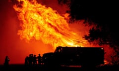 Flames tower over a fire engine during Bear fire in Oroville, California.