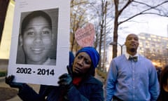 A woman holds up a poster of Tamir Rice during a protest in Washington DC in 2014.