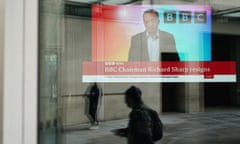 A screen showing a news report seen through the windows of the BBC in central London, after chairman Richard Sharp announced he was quitting.