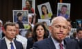 Family members of victims of Boeing Max 8 crashes hold up photographs of their loved ones