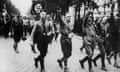 A Nazi parade in Vienna in about 1930, with marchers holding swastikas and giving Nazi salutes