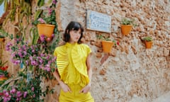 Model wearing yellow sleeveless top and trousers
