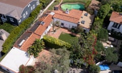 An overhead of a Spanish colonial-style house surrounded by greenery