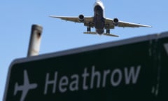 A plane passes a sign as it comes into land at Heathrow airport