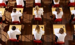 Students in a hall sitting exams seen from above