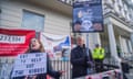 Protesters hold signs in reference to the ‘eat out to help out’ scheme outside the covid inquiry hearing centre in London.