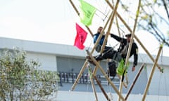 Extinction Rebellion protesters use bamboo lock-ons to block the road outside the Rupert Murdoch-owned Newsprinters works in Hertfordshire on 5 September.