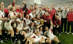 England head coach Clive Woodward and his squad and staff celebrate after winning the 2003 Rugby World Cup final