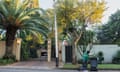 A waste-picker sorts through a bag of rubbish from bins outside a gated residence in a wealthy suburb of Johannesburg.