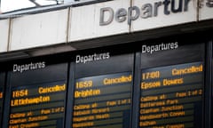 Departure boards at London's Victoria railway station display a list of cancelled trains