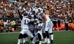 Toronto Argonauts players celebrate with a selfie pose after a touchdown that ended up being disallowed, against the Hamilton Tiger-Cats during in CFL