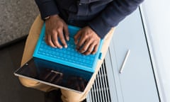 African-American man using computer FREE TO US ONLY WITH THE CREDIT Detail of hands on laptop