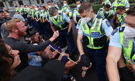 Anti-vaccine protesters clash with police outside New Zealand parliament – video