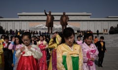 A group of women wearing traditional dress leave after paying their respects before the statues of Kim Il-sung and Kim Jong-il