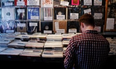 A man looks through vinyl records in front of a wall of limited edition records made available for Record Store Day at the Rough Trade record shop in London<br>A man looks through vinyl records in front of a wall of limited edition records made available for Record Store Day, at the Rough Trade record shop in London April 18, 2009. The day aimed to celebrate independent record stores. REUTERS/Luke MacGregor (BRITAIN ENTERTAINMENT BUSINESS)