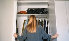 Woman organising closet at home.