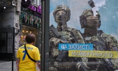 Anatoliy walks home from a match past one of the war messaging billboards in Odesa that are now ubiquitous in Ukraine. The sign reads “In Defence of the Future”. Euros in Ukraine 12