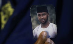 Amina Ahmed, the wife of  Mubarak Bala, holds his picture in her home in Abuja, Nigeria.