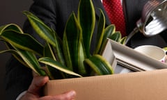 A worker leaves their job with a box full of their possessions