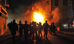 Riot police near a burning building in Croydon, south London, during the riots in the UK capital in August 2011.