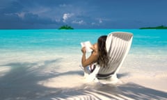 Woman reading a book on the beach