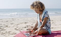 woman on laptop on beach